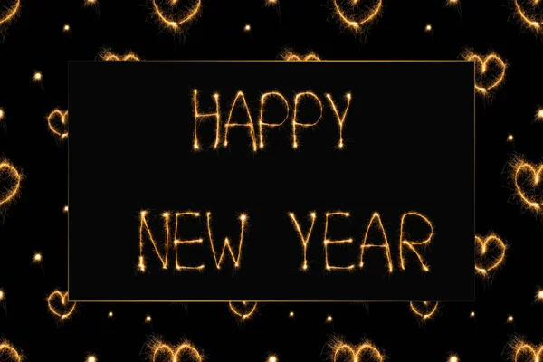 Close up view of happy new year light lettering and hearts light signs on black backdrop — Stock Photo
