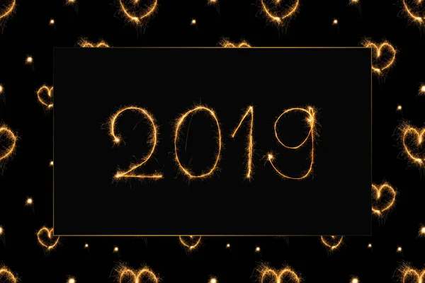 2019 and hearts light sings on black background — Stock Photo