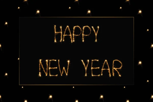 Close up view of happy new year light lettering on black backdrop — Stock Photo