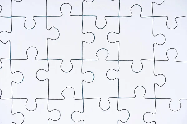 Full frame of white puzzle pieces background — Stock Photo