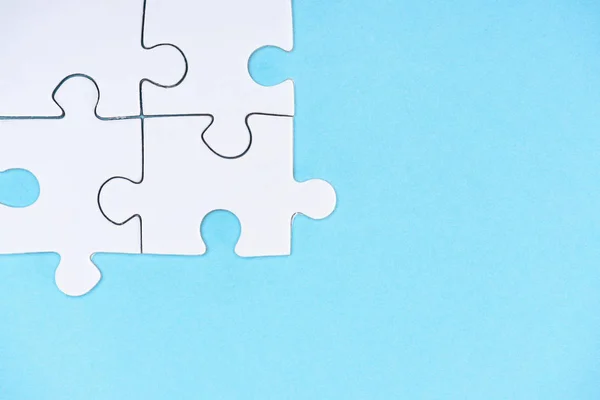 Top view of white puzzle pieces isolated on blue — Stock Photo