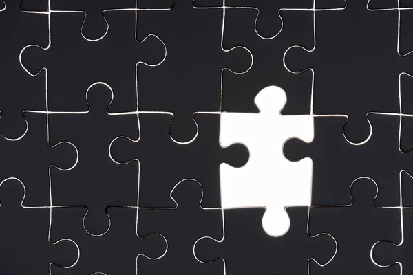 Full frame of black and white puzzle pieces background — Stock Photo