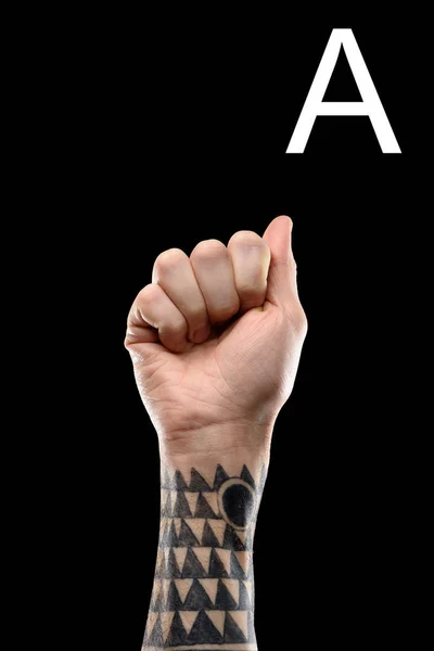 Tattooed male hand showing latin letter - A, sign language, isolated on black — Stock Photo