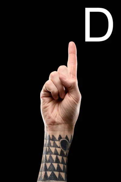 Tattooed hand showing latin letter - D, sign language, isolated on black — Stock Photo