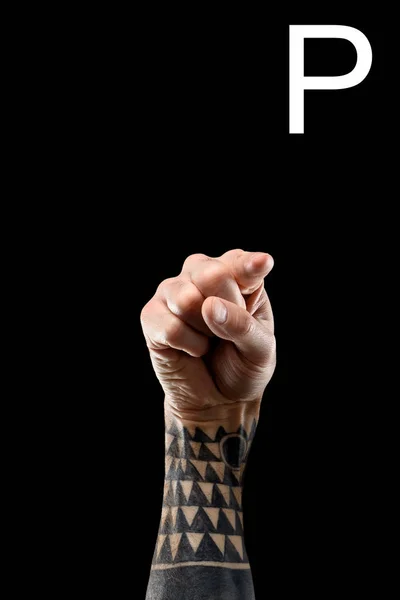 Cropped view of tattooed hand showing latin letter - P, sign language, isolated on black — Stock Photo