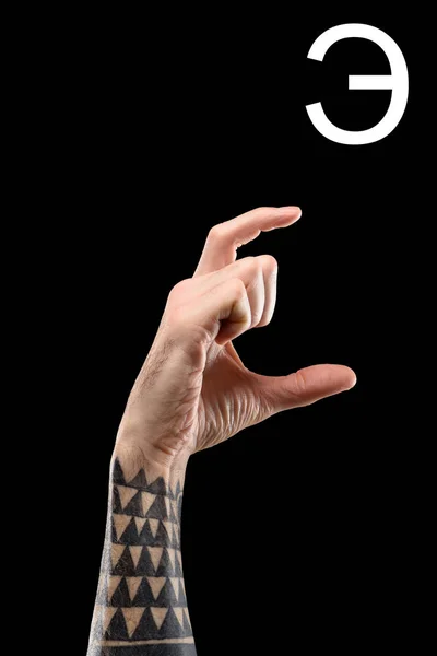 Vue recadrée de la main tatouée mâle montrant la lettre cyrillique, langage sourd et muet, isolé sur noir — Photo de stock