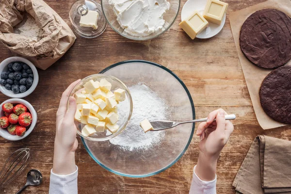 Vista dall'alto parziale della donna che mescola ingredienti e prepara la pasta per la torta fatta in casa — Foto stock