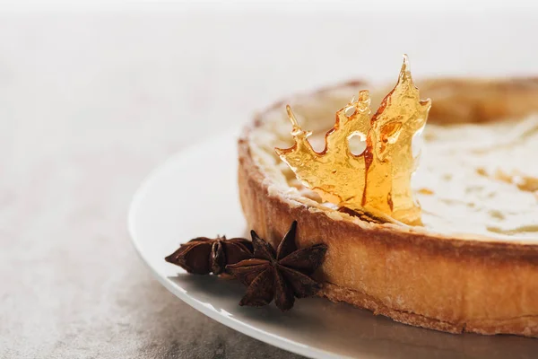 Close-up view of delicious flan cake with caramel and star anise on white plate — Stock Photo