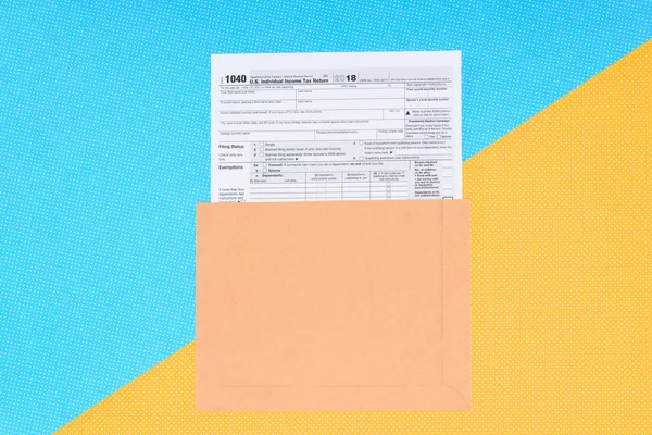 Top view of tax form on blue and yellow background with copy space — Stock Photo