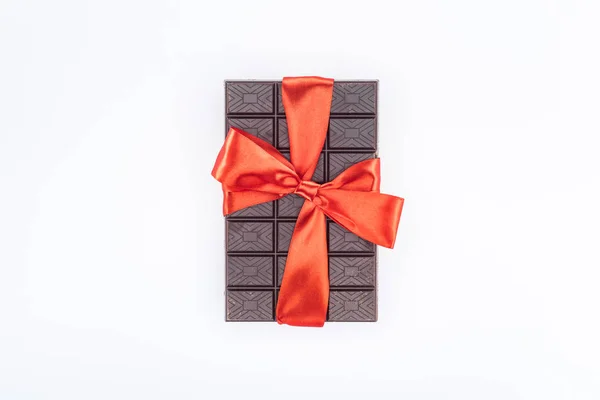 Top view of delicious chocolate wrapped by festive ribbon isolated on white, st valentine day concept — Stock Photo