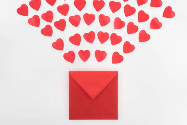 View from above of heart symbols and envelope isolated on white, st valentine day concept — Stock Photo