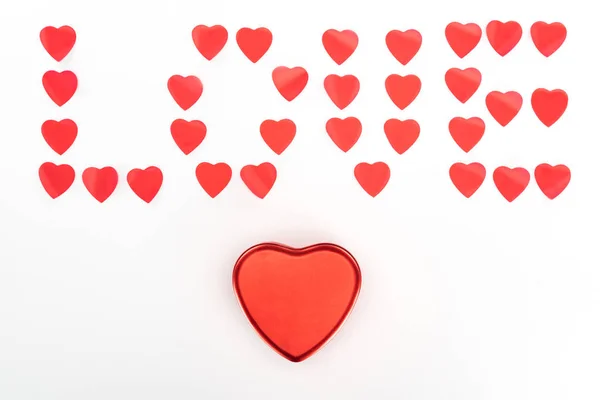 Vista dall'alto della scatola regalo a forma di cuore e l'amore lettering fatto di simboli del cuore isolati su bianco, concetto di giorno di San Valentino — Foto stock