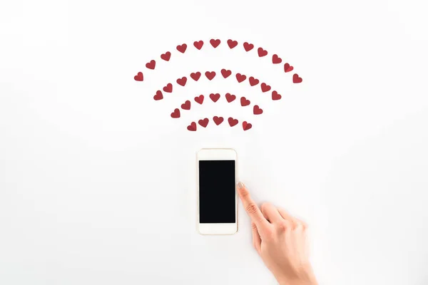 Imagem cortada de mulher usando smartphone com tela em branco sob símbolos coração vermelho isolado no branco, st conceito dia dos namorados — Fotografia de Stock