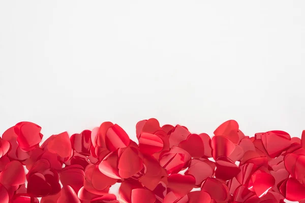 Vue rapprochée de beaux pétales rouges en forme de coeur sur fond gris, concept de Saint-Valentin — Photo de stock