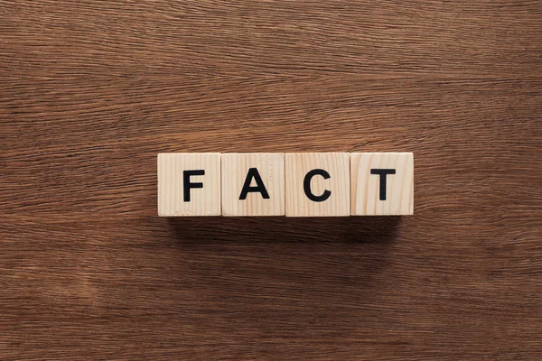 Top view of wooden cubes with word fact on wooden tabletop — Stock Photo