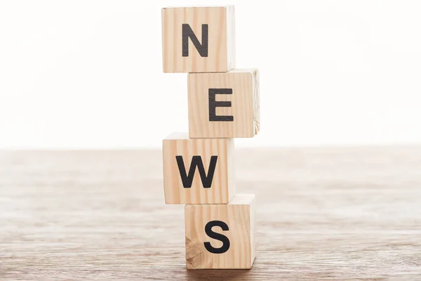 Wooden cubes with word news on wooden tabletop — Stock Photo