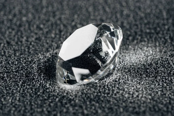 Close up of pure diamond on grey textured background — Stock Photo