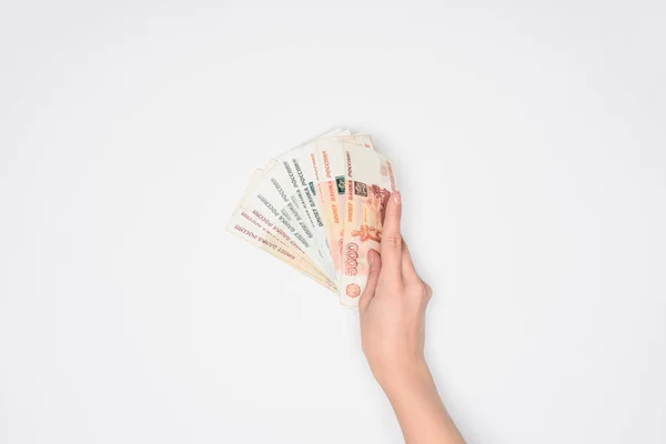 Cropped view of woman holding Russian rubles in hand isolated on grey — Stock Photo