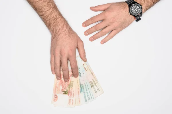 Partial view of man holding Russian rubles isolated on grey — Stock Photo