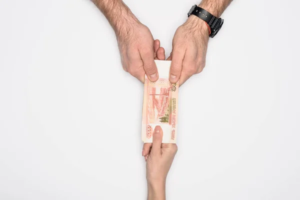 Partial view of man and woman holding together Russian banknote isolated on grey — Stock Photo