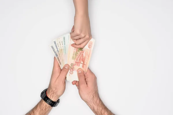 Partial view of man and woman holding together Russian rubles isolated on grey — Stock Photo