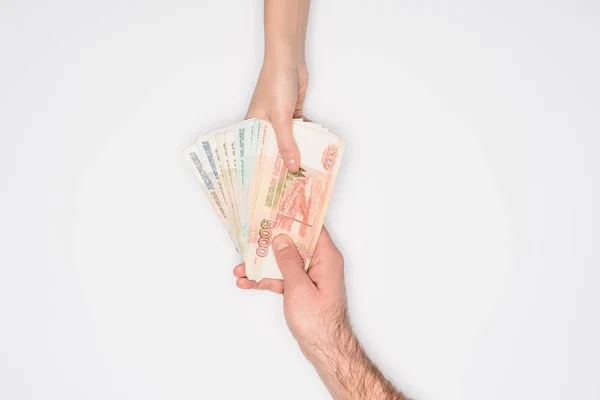 Cropped view of man and woman holding together Russian rubles isolated on grey — Stock Photo