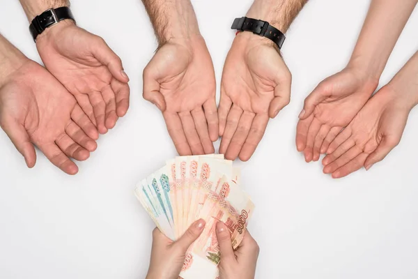 Cropped view of woman giving group of people russian banknotes isolated on grey — Stock Photo