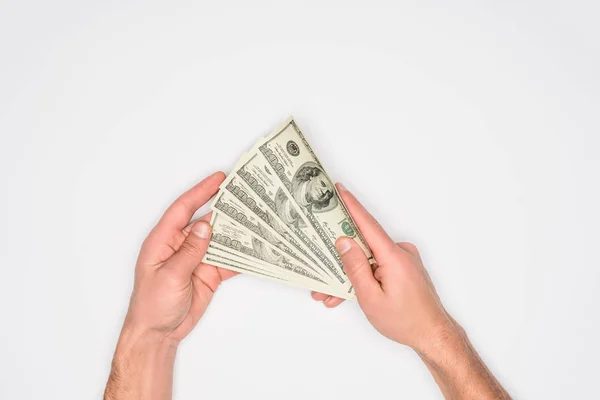 Partial view of man holding money in hands isolated on grey — Stock Photo