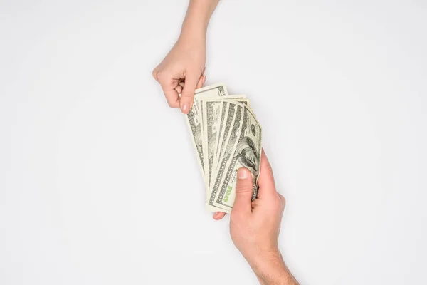 Cropped view of couple sharing dollars isolated on grey — Stock Photo