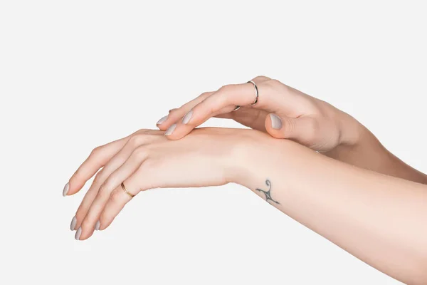 Cropped view of female hands with rings isolated on white — Stock Photo