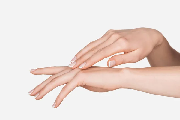 Vista parcial de las manos femeninas aisladas en blanco — Stock Photo