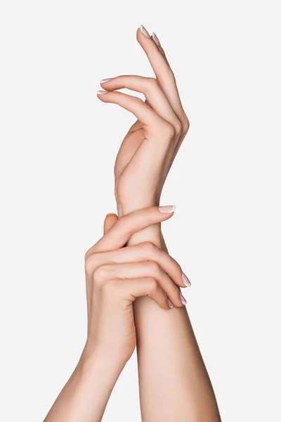 Vista recortada de las manos femeninas aisladas en blanco - foto de stock
