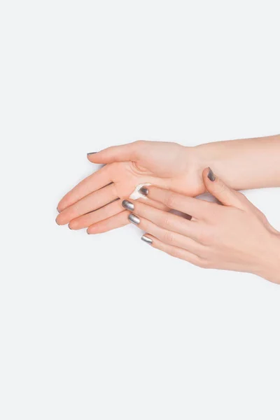 Partial view of woman applying hand cream isolated on white — Stock Photo