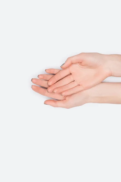 Vista superior de mãos femininas isoladas em branco — Fotografia de Stock
