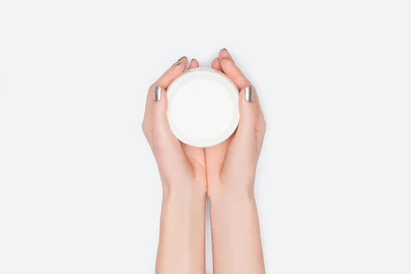 Cropped view of woman holding hand cream isolated on white — Stock Photo