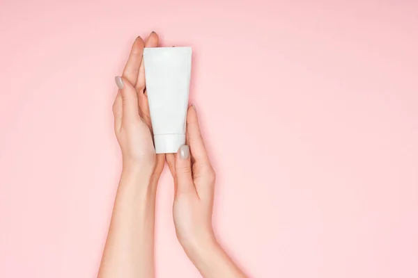 Top view of female hands with hand cream isolated on pink — Stock Photo