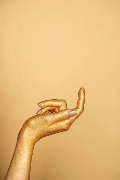 Обрізаний вид жіночої пофарбованої руки ізольовано на золоті з пробілом для копіювання — стокове фото