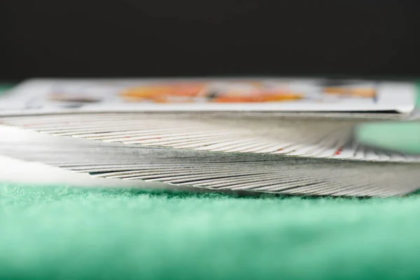 Selective focus of playing cards in deck on green table — Stock Photo