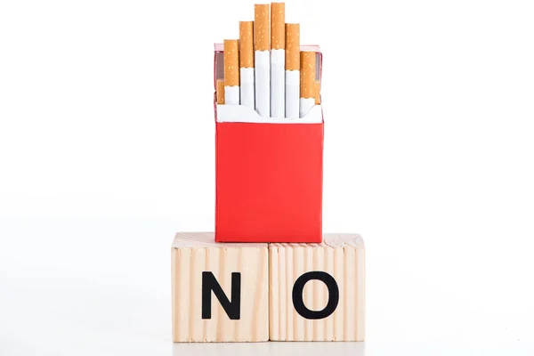 Studio shot of cigarette pack with wooden alphabet cubes isolated on white, stop smoking concept — Stock Photo