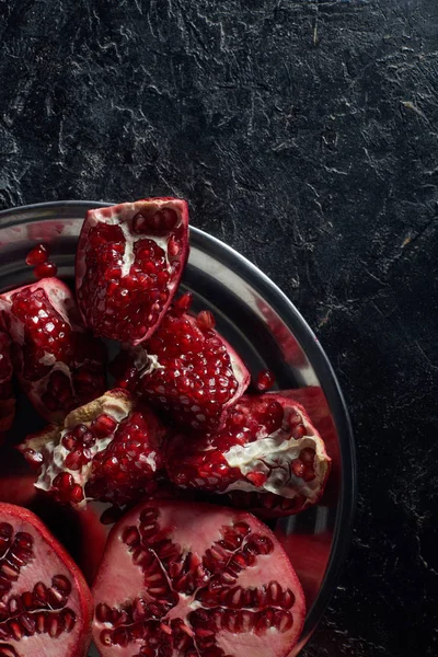 Top view of cut pomegranates in metal bowl — Stock Photo