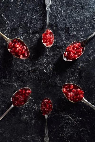 Flat lay with old cutlery and garnet seeds on textured background — Stock Photo