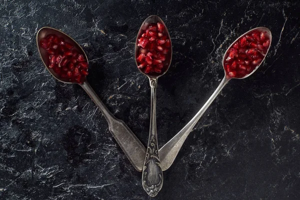 Flat lay with silverware and garnet seeds — Stock Photo