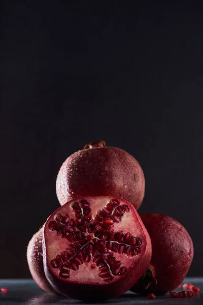 Studio shot of ripe pomegranates on black background — Stock Photo