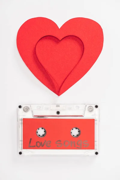 Draufsicht auf Audiokassette mit 'Liebesliedern' Schriftzug und Herzsymbolen isoliert auf weißem, Valentinstag-Konzept — Stockfoto