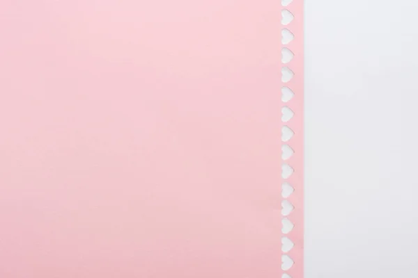 Background of cut out hearts in row on pink paper isolated on white with copy space — Stock Photo