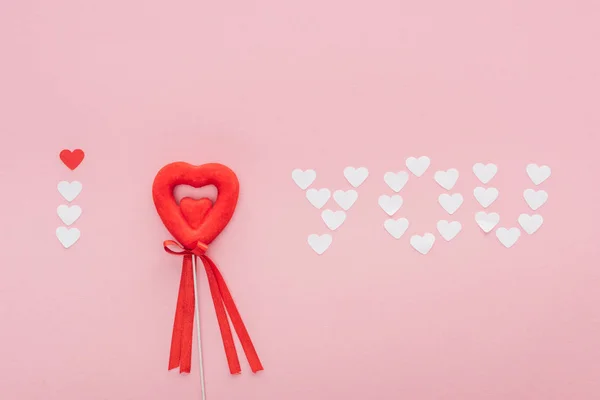 Top view of 'i love you' lettering made of paper hearts and heart shaped decoration isolated on pink, st valentines day concept — Stock Photo