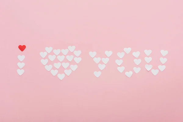 Top view of 'i love you' lettering made of paper hearts isolated on pink, st valentines day concept — Stock Photo