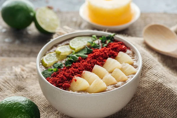 Selective focus of smoothie bowl with fresh fruits on sackcloth — Stock Photo