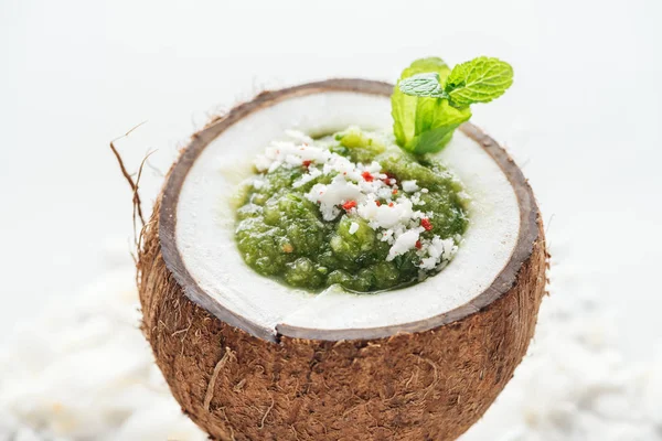 Fresh green smoothie in coconut decorated with mint — Stock Photo