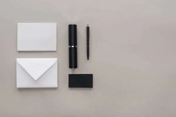 Flat lay with black and white stationery on grey background — Stock Photo